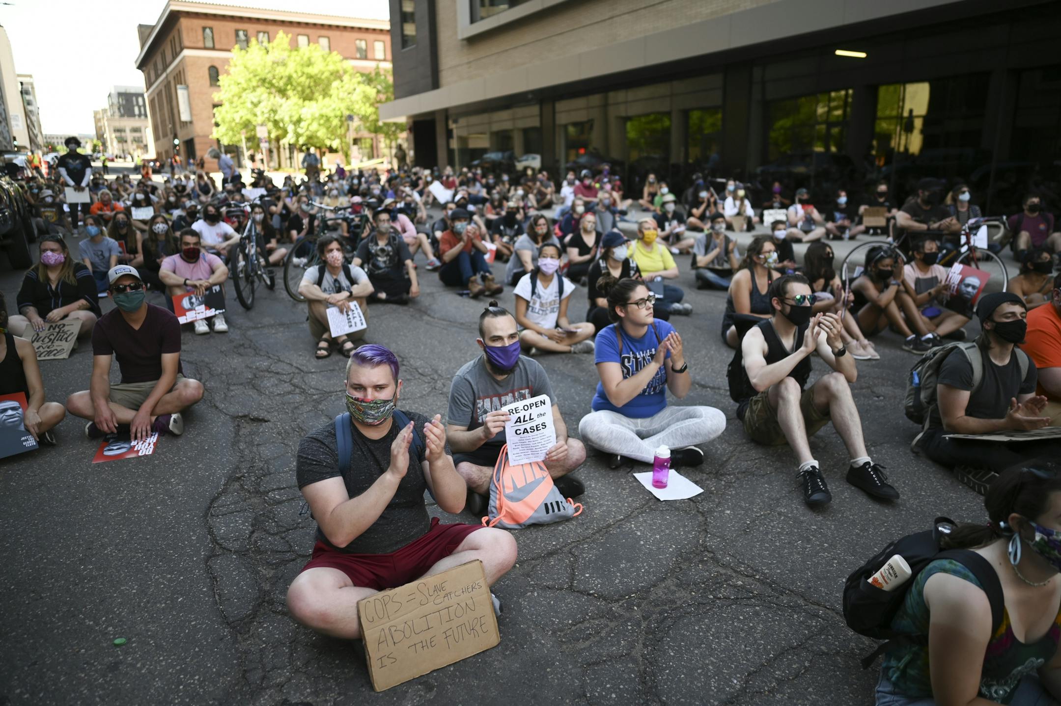 Protesters applauded as men of color were recognized during a demonstration outside Minnesota Attorney General Keith Ellison's office Friday afternoon.