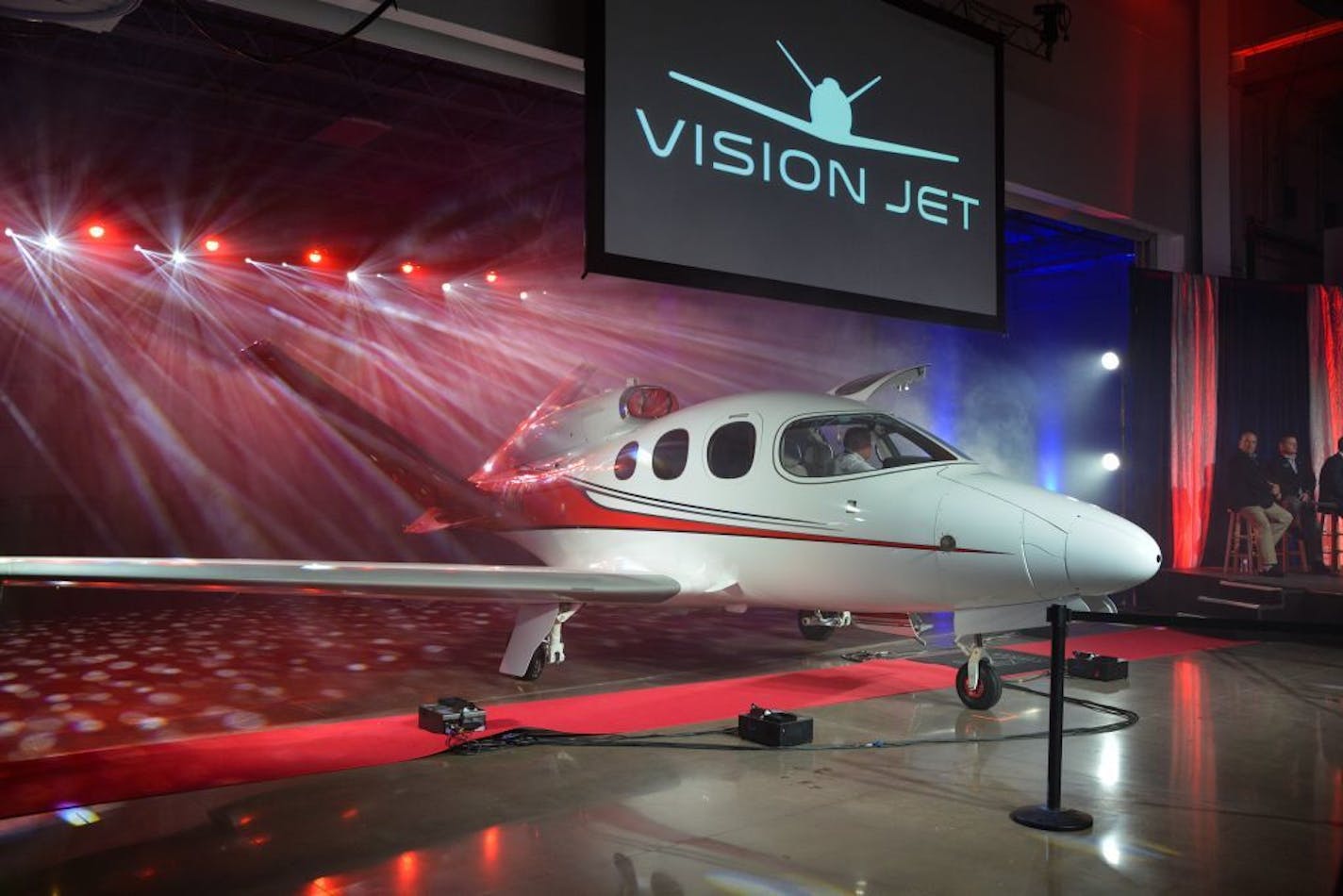 Cirrus Aircraft Vision Jet customer #1 Joe Whisenhunt escorts his family off their brand new aircraft -- the world's first single engine "Personal Jet" -- at Monday's celebration at the new Duluth Vision Jet Finishing Facility. Pictured is wife Connie, baby Eleanor and son Zeke. Credit: Mike Young