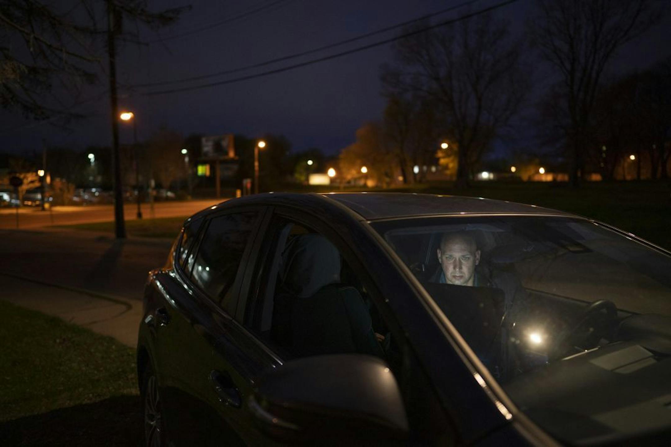 ISR Agent Ricard Defiel wrote up a report from his last visit on a laptop while parked in a vacant lot on W. Broadway Ave. in Minneapolis. He was between random visits with former prison inmates on supervised release Monday night.