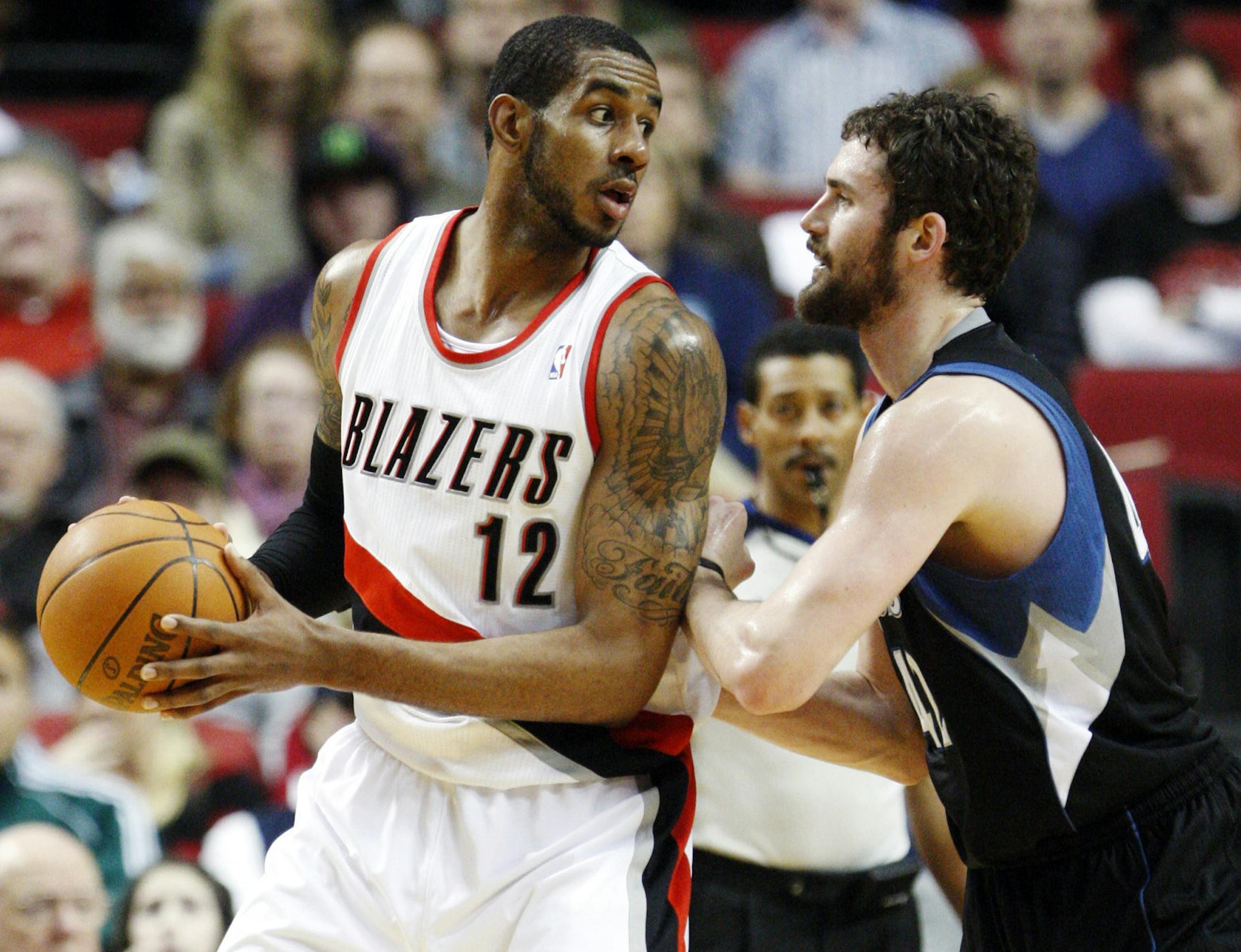 Minnesota Timberwolves' Kevin Love, right, defends against Portland Trail Blazers' LaMarcus Aldridge (12) in the first quarter of an NBA basketball game, Sunday, April 1, 2012, in Portland, Ore. (AP Photo/Rick Bowmer) ORG XMIT: MIN2013122018493071