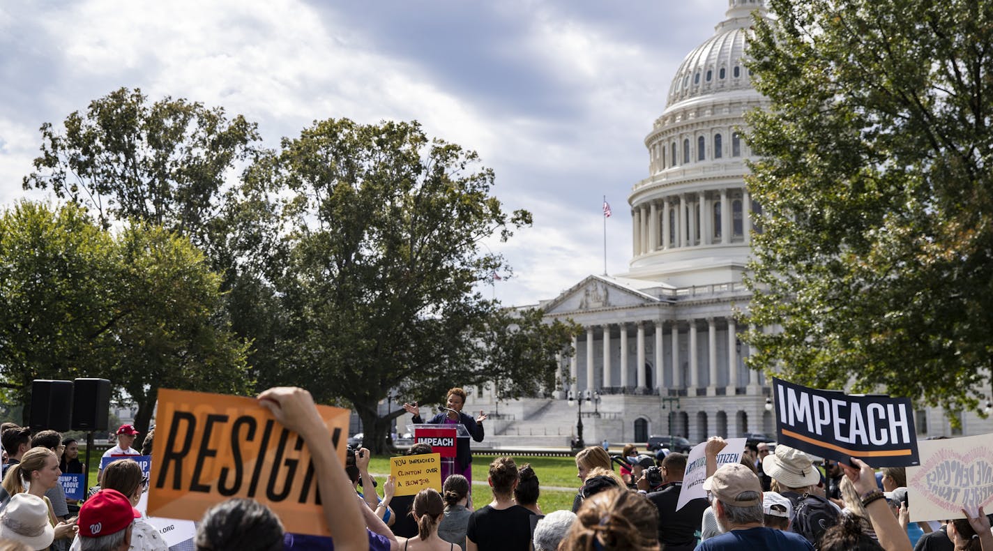 FILE -- Protesters hold signs as Rep. Barbara Lee (D-Calif.) speaks at a rally in support of the impeachment of President Donald Trump in Washington, Sept. 26, 2019. Republicans who cast the impeachment inquiry as a yet another partisan character assassination may find it difficult to rally the same kind of unified support that helped Brett Kavanaugh. (Anna Moneymaker/The New York Times)