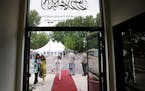 People mingle outside of the Nusrat Mosque prior to the start of an inauguration Saturday, May 23, 2015, for the Mosque in Coon Rapids, the first and 