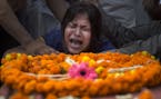 An Indian girl cries near the coffin of her mother Hema Prabha Saikia, a victim of Saturday�s earthquake in Nepal, in Gauhati, India, Wednesday, Apr