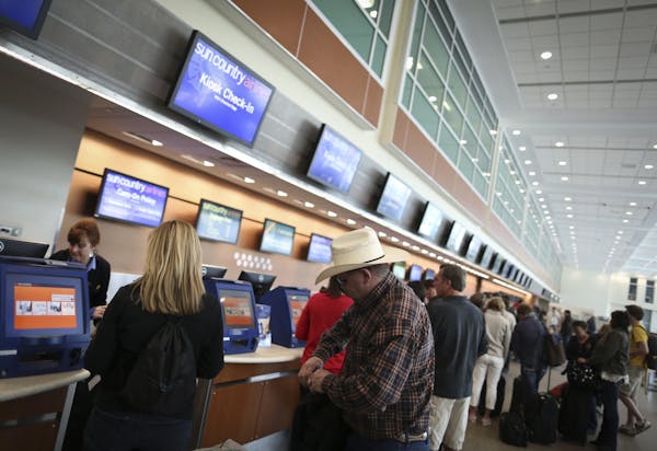 Passengers checked in for flights at the Sun Country ticket counter at Terminal 2 at Minneapolis-St. Paul Airport in 2014.