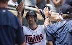 Minnesota Twins second baseman Brian Dozier (2) celebrated with teammates in the dugout after hitting a solo home run to bring the score 5-3 in the fi