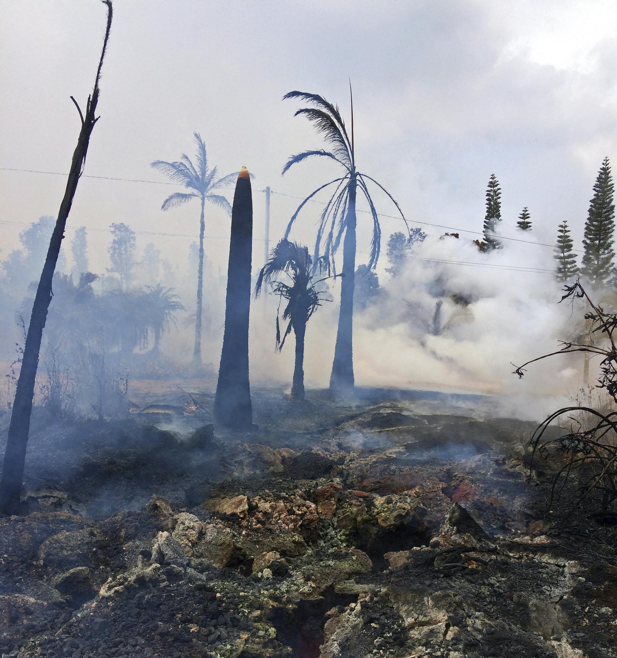 This photo provided by the U.S. Geological Survey shows severe ground cracks associated with what's known as Fissure 14 beneath a burned-out landscape in Leilani Estates near the town of Pahoa, Hawaii, Wednesday, May 9, 2018. Geologists warned Wednesday that Hawaii's Kilauea volcano could erupt explosively and send boulders, rocks and ash into the air around its summit in the coming weeks. (U.S. Geological Survey via AP)