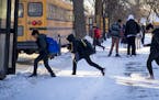 Students ran to their bus in the bitter cold after school at Sanford Middle School on Tuesday, January 16, 2018, in Minneapolis, Minn. Sanford and all