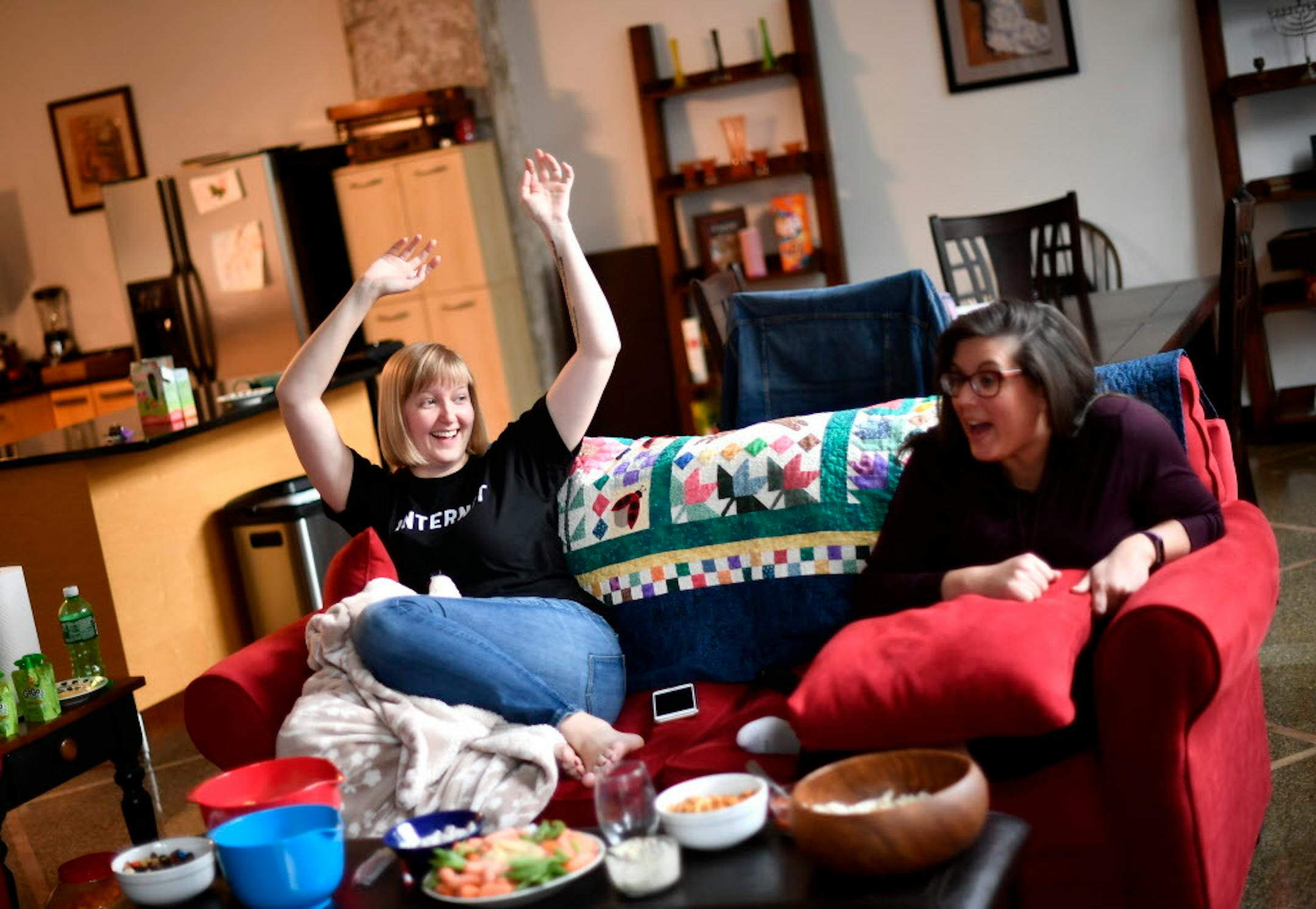 Katie Sisneros, left, celebrated as it was announced that a future episode of "The Great British Bake Off" would include savory pastries. To her right, friend Amy Wielunski. ] (AARON LAVINSKY/STAR TRIBUNE) aaron.lavinsky@startribune.com "The Great British Bake Off/Baking Show" has inspired a wave of fanatics. We talk to super fans about why this show is so popular here, how they felt when they heard most of the cast was leaving, and how it has affected their lives and their baking. We photograph
