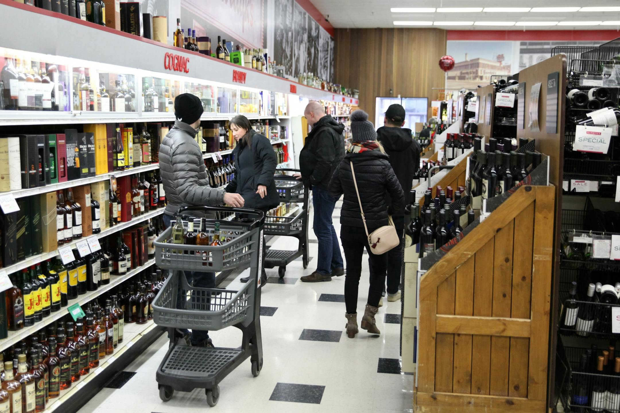 People come to shop in the Surdyk's liquor store on Sunday. March 12, 2017.