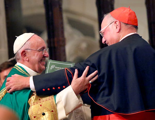 Pope Francis embraces Cardinal Timothy Dolan after leading vespers service at St. Patrickís Cathedral in New York, Sept. 24, 2015. Francis began his 