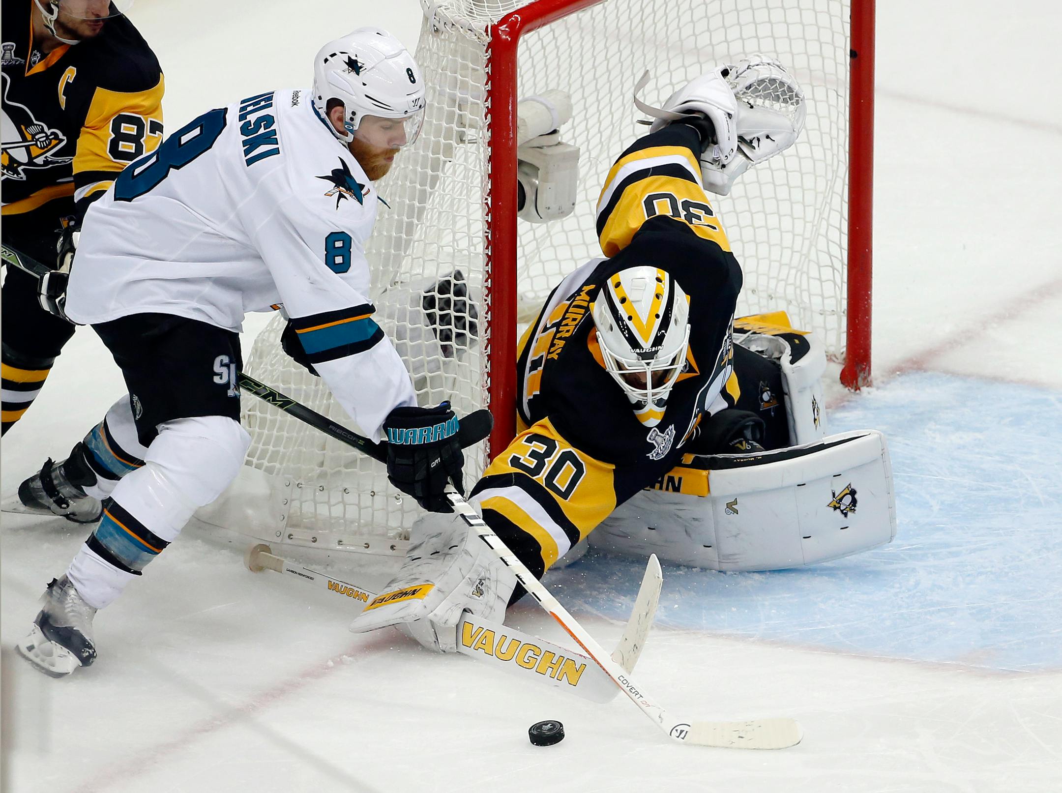 Pittsburgh Penguins goalie Matt Murray (30) pokes the puck away from San Jose Sharks' Joe Pavelski (8) during the third period in Game 2 of the NHL hockey Stanley Cup Finals on Wednesday, June 1, 2016, in Pittsburgh. (AP Photo/Gene J. Puskar)
