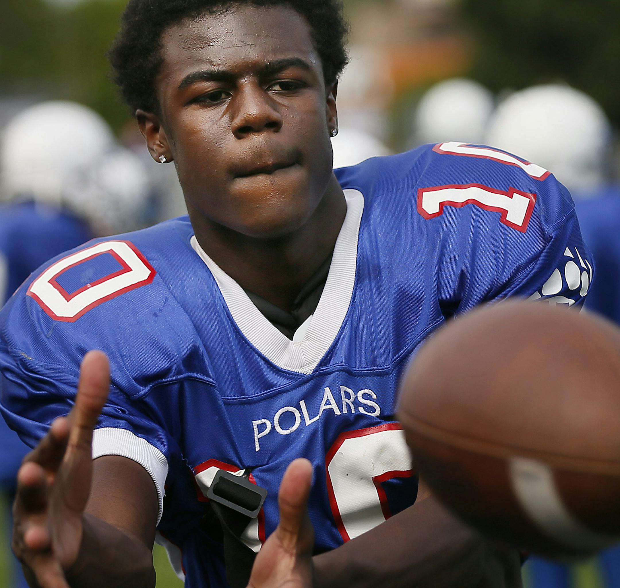 Tyler Johnson warmed up with his team during high school football practice at North High School Monday August 18 , 2014 in Minneapolis ,MN . ] Jerry Holt Jerry.holt@startribune.com