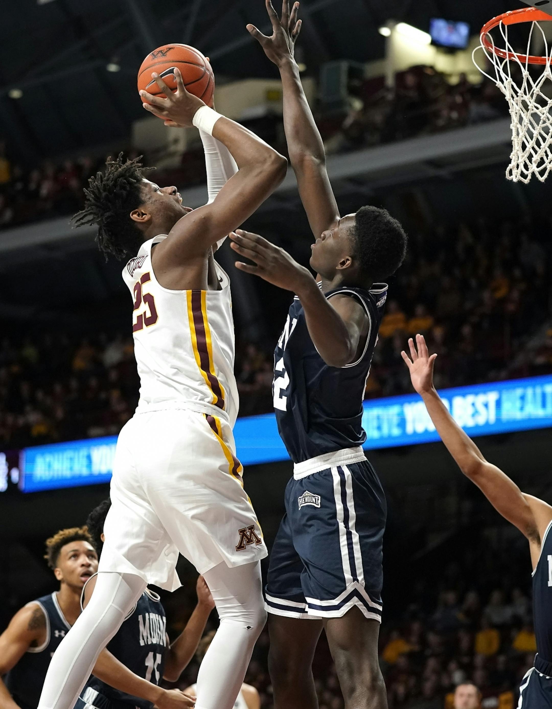 Minnesota center Daniel Oturu (25) shoots as Mount St. Mary's forward Nana Opoku (22) tries to block during the first half.