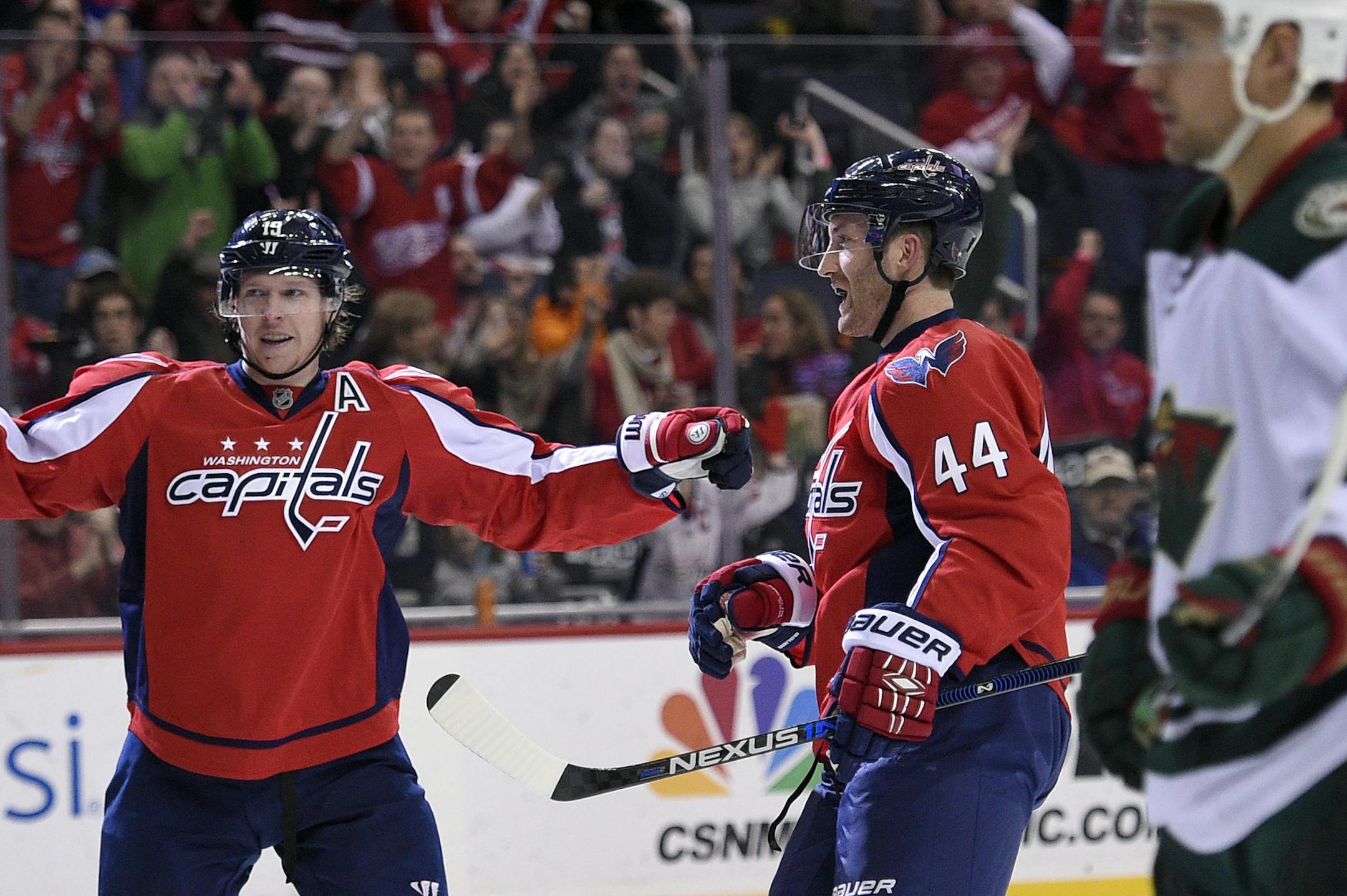 Washington Capitals defenseman Brooks Orpik (44) celebrates his goal with center Nicklas Backstrom (19), of Sweden, and left wing Alex Ovechkin (8), of Russia, during the second period of an NHL hockey game, as Minnesota Wild right wing Nino Niederreiter (22) skates by, Friday, Feb. 26, 2016, in Washington. (AP Photo/Nick Wass)