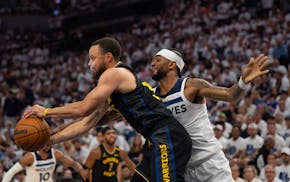 Golden State Warriors guard Stephen Curry (30) reaches for a pass while defended by Timberwolves guard Nickeil Alexander-Walker (9) in the second quar