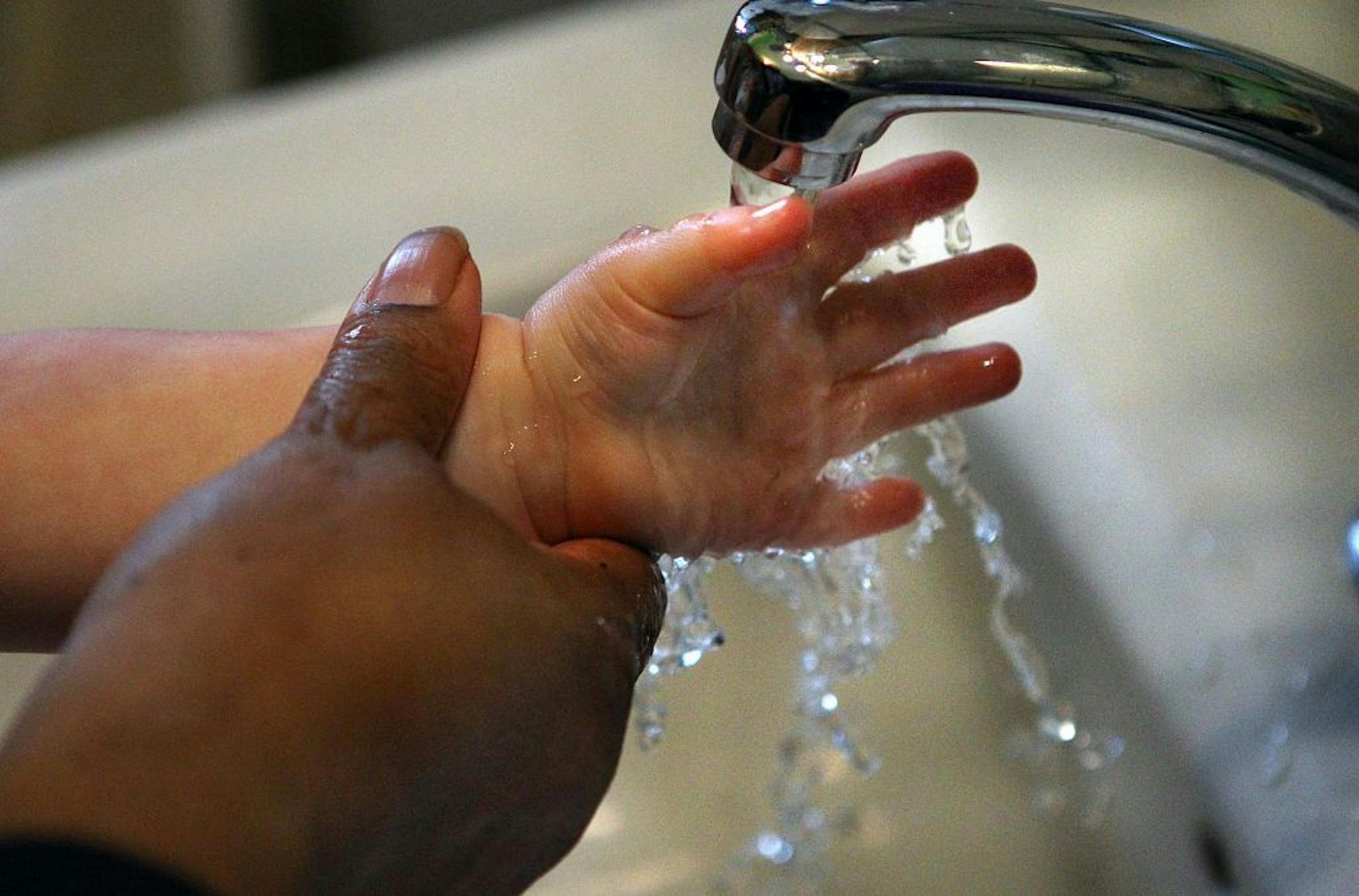Daycare employee Sybil Smith washed the hands of a toddler at the home of daycare provider Marian Turner (not pictured). Smith said she has been a daycare worker for 8 1/2 years.