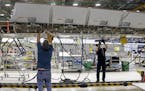 Workers assembly a Boeing's 737 MAX airplane wing at the company's production facility Monday, Feb. 13, 2017, in Renton, Wash. Boeing plans to deliver