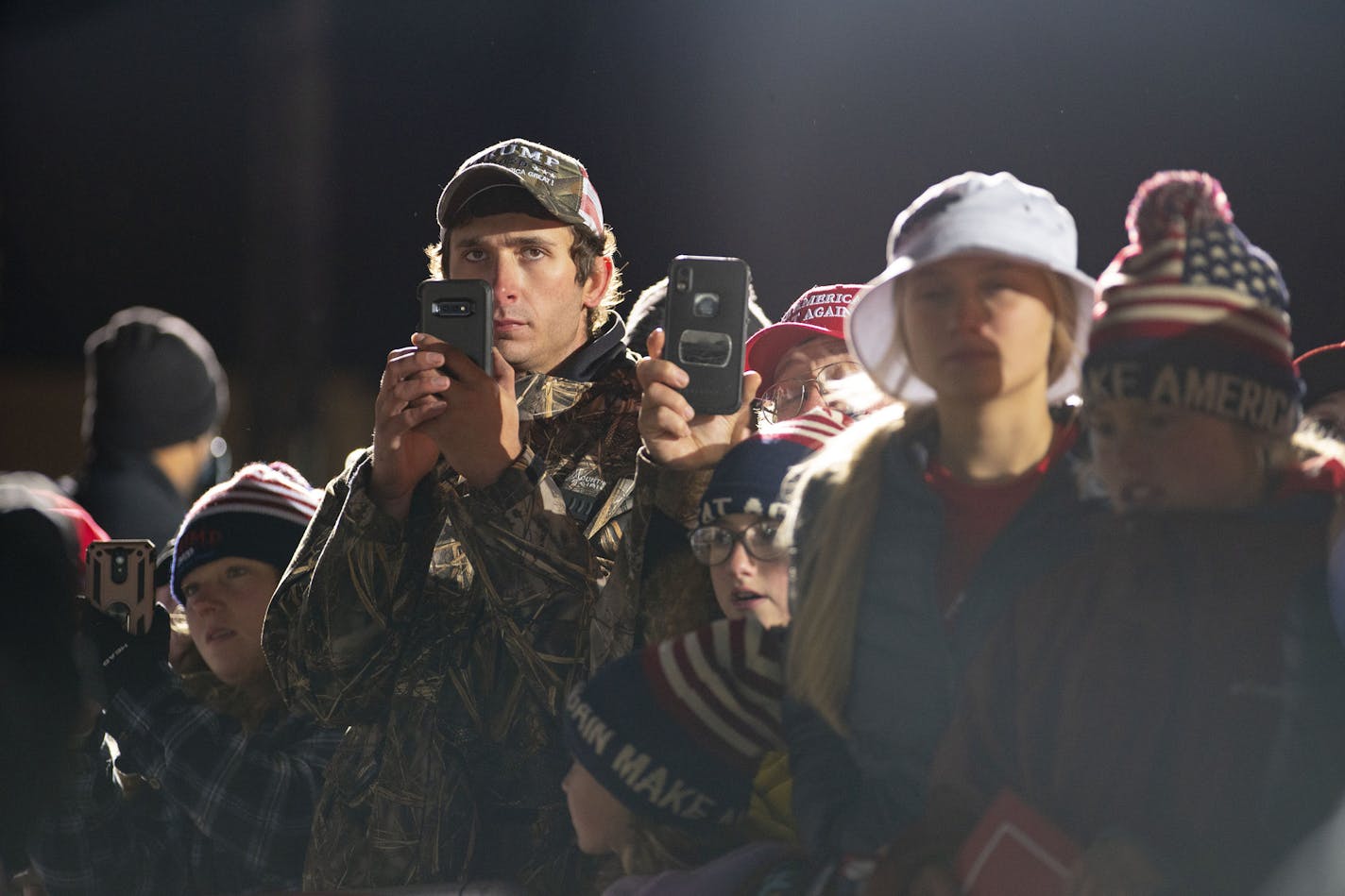 Trump supporters took videos and photos of President Trump as he walked onto the stage at Duluth International Airport on Wednesday September 30, 2020. ] ALEX KORMANN • alex.kormann@startribune.com President Trump visited Duluth on Wednesday September 30, 2020 as one of multiple campaign stops in Minnesota that day. The President spoke at Duluth International Airport starting around 8PM. The campaign event comes just 24 hours after the first Presidential debate took place in Cleveland.