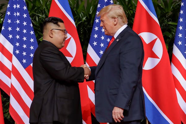 U.S. President Donald Trump shakes hands with North Korea leader Kim Jong Un at the Capella resort on Sentosa Island Tuesday, June 12, 2018 in Singapo