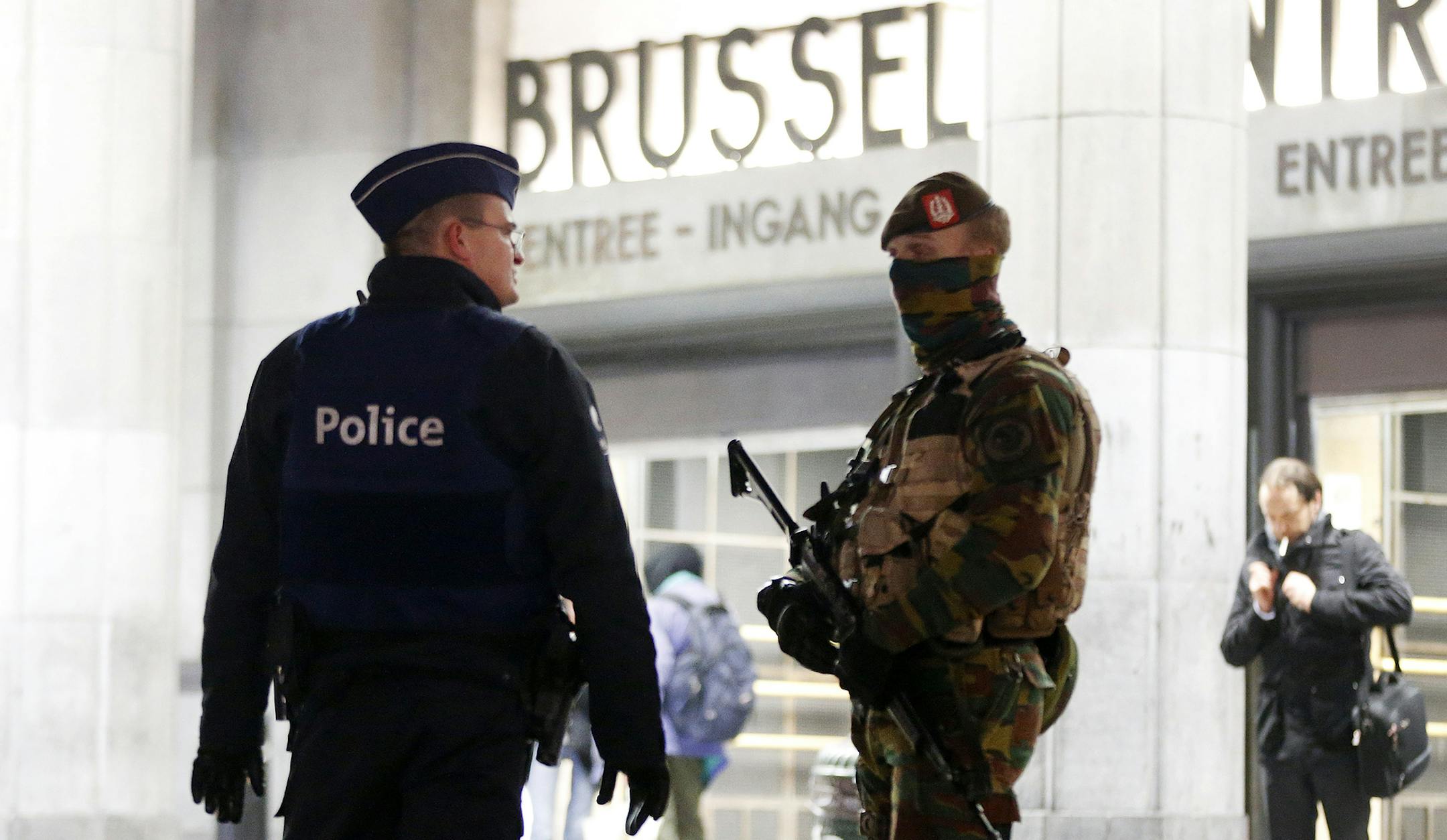 Belgium police officers talk to each other in front of the central station in downtown Brussels, Belgium, Monday, Nov. 23, 2015. The Belgian capital Brussels has entered its third day of lockdown, with schools and underground transport shut and more than 1,000 security personnel deployed across the country. (AP Photo/Michael Probst) ORG XMIT: MIN2015112314130926