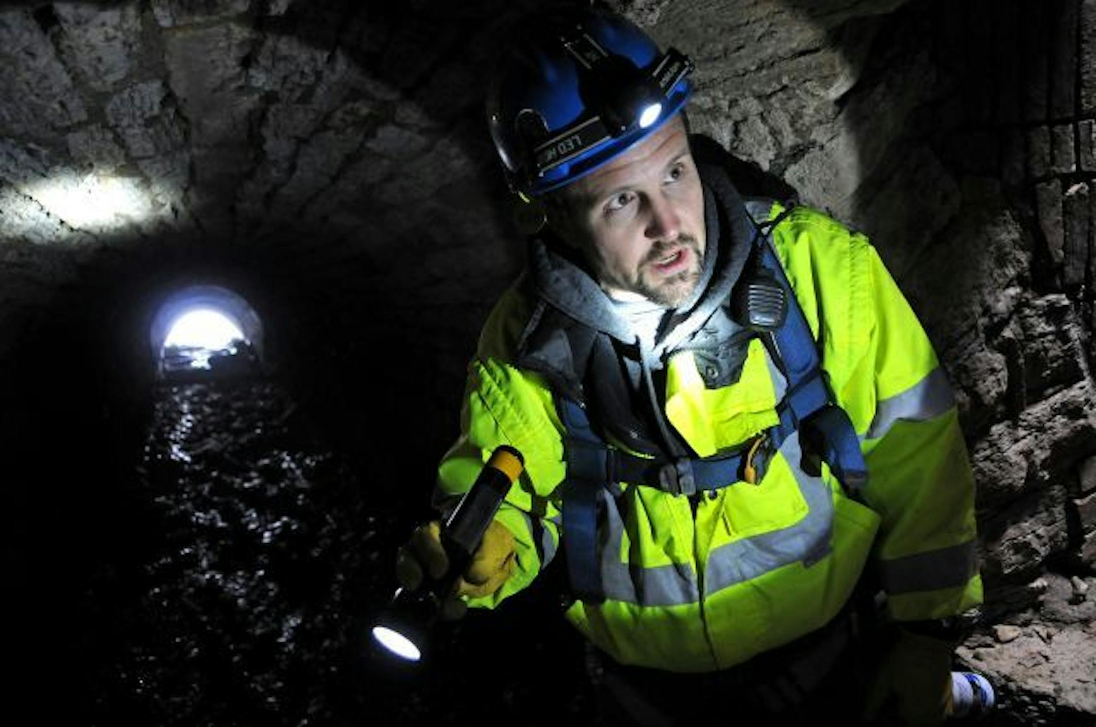 Minneapolis,M n. Wednesday 11/17/10 Kevin Danen who is Principal Professional Engineer, Department of Public Works walks through a storm sewer tunnel that has a brick floor built in 1882. The city is going ahead with the $20-plus milliopn dollar acceleration of a maintenance program designed to keep the sewers from collapsing and the rock around them from eroding. The bright light at the end of the tunnel is daylight and the Mississippi River.