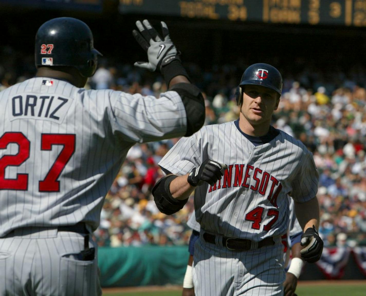 Twins teammates Corey Koskie (47) and David Ortiz in 2002.