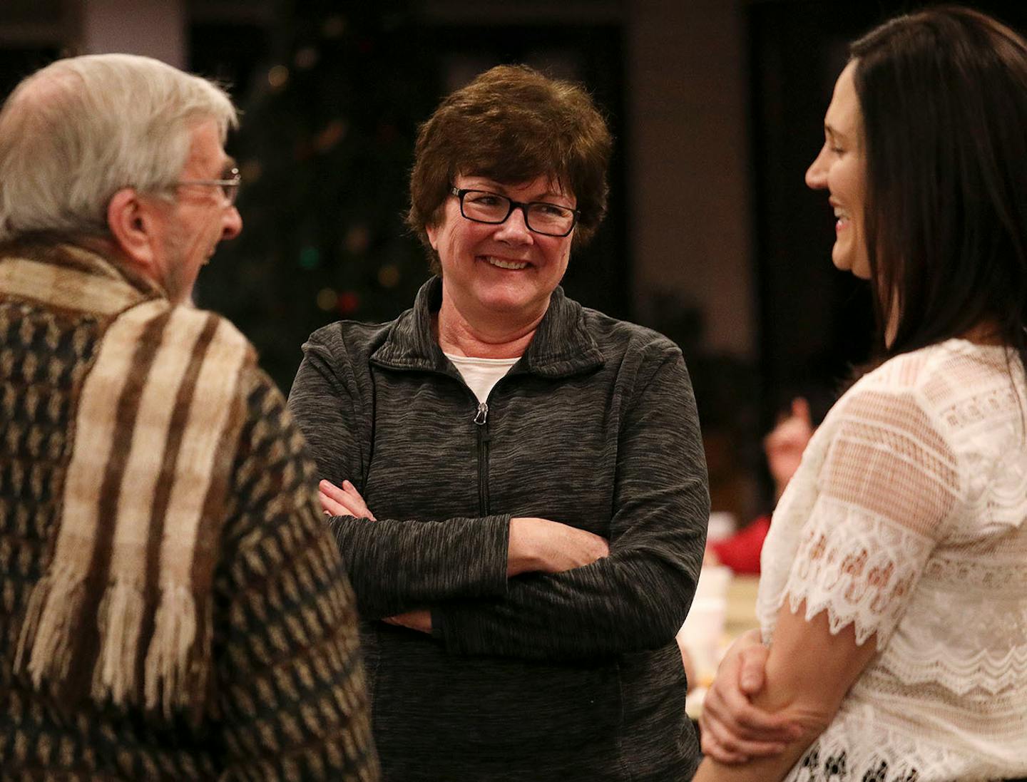 New Brighton mayor Valerie Johnson, center, talked with others during a reception following the vigil.