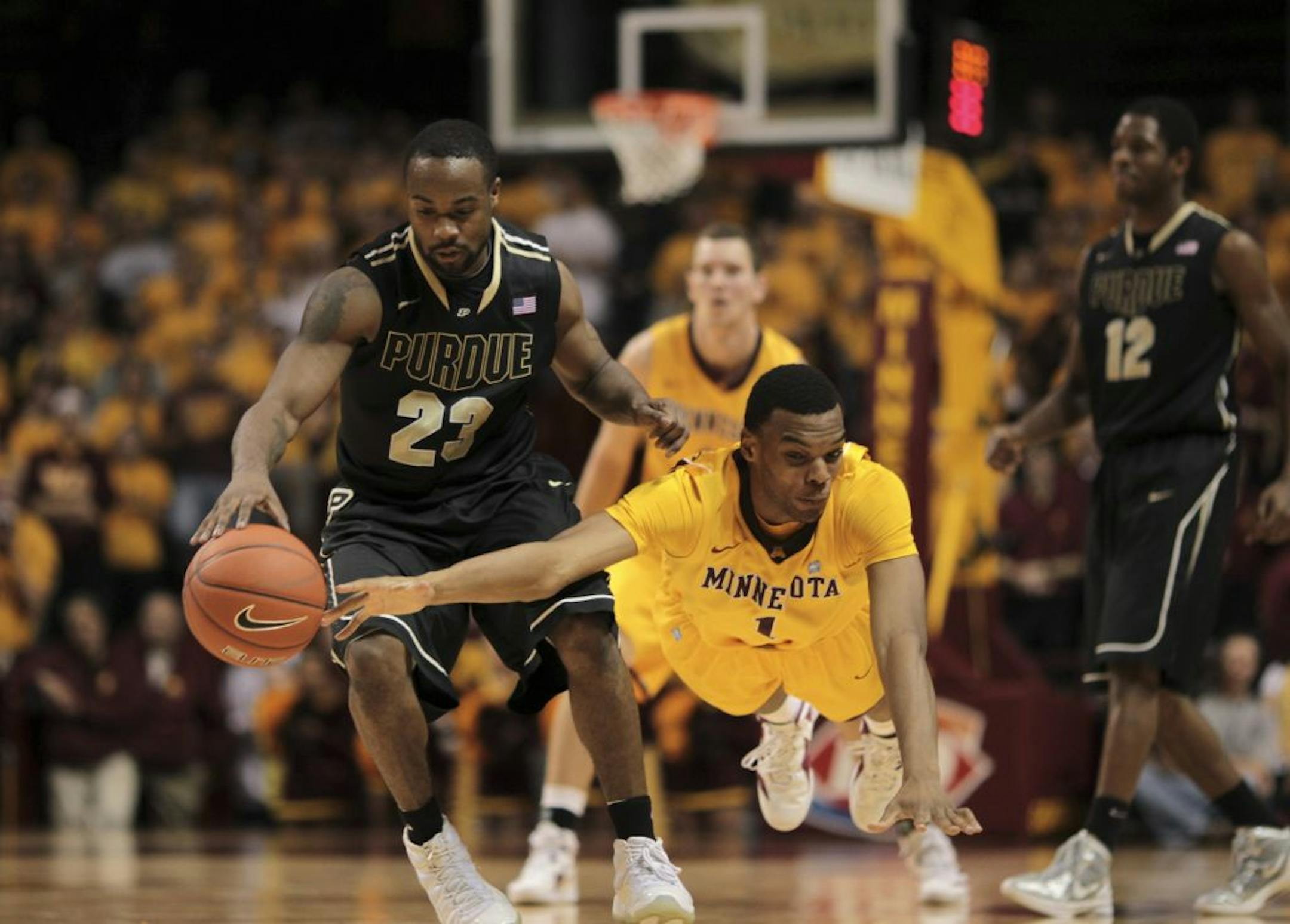 Minnesota's Andre Hollins dives for a loose ball against Purdue last month.