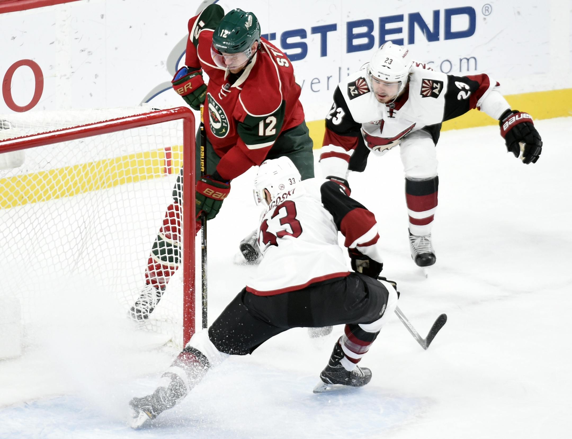 Minnesota Wild center Eric Staal (12) scores an empty net goal against Arizona Coyotes defensemen Alex Goligoski (33) and Oliver Ekman-Larsson (23), of Sweden, during the third period of an NHL hockey game, Saturday, Dec. 17, 2016, in St. Paul, Minn. The Wild won 4-1.