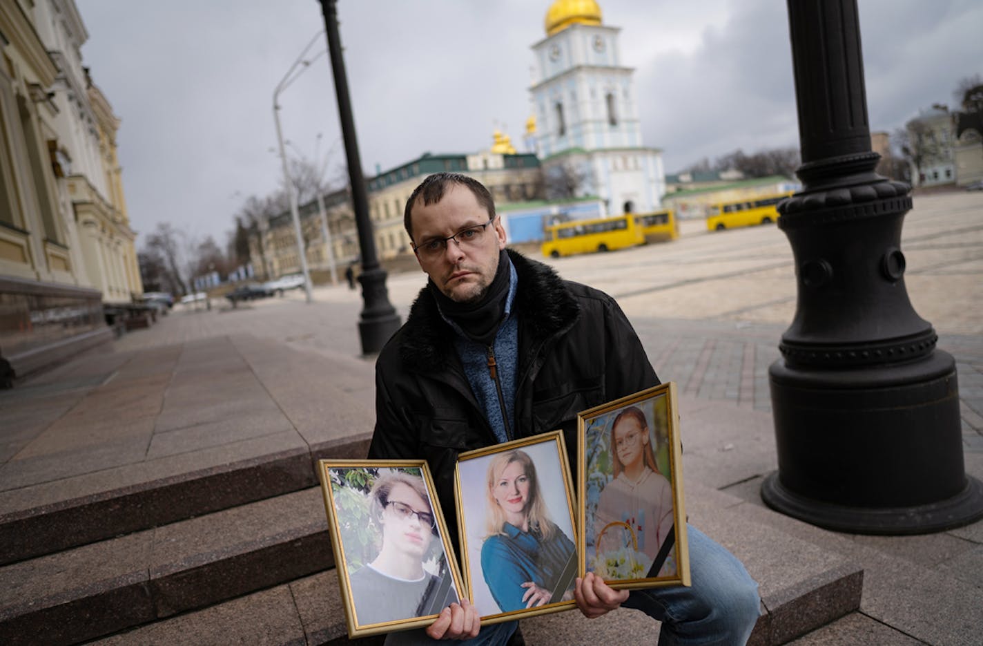 Serhiy Perebyinis holds portraits of his wife, Tetiana, and children Mykyta, 18, and Alisa, 9, who were killed by Russian mortar fire as they tried to evacuate two days earlier, in Kyiv, Ukraine, on Wednesday, March 9, 2022. Serhiy said he felt it was important that their deaths had been recorded in photographs and video. ÒThe whole world should know what is happening here,Ó he said. (Lynsey Addario/The New York Times) Ñ NO SALES Ñ