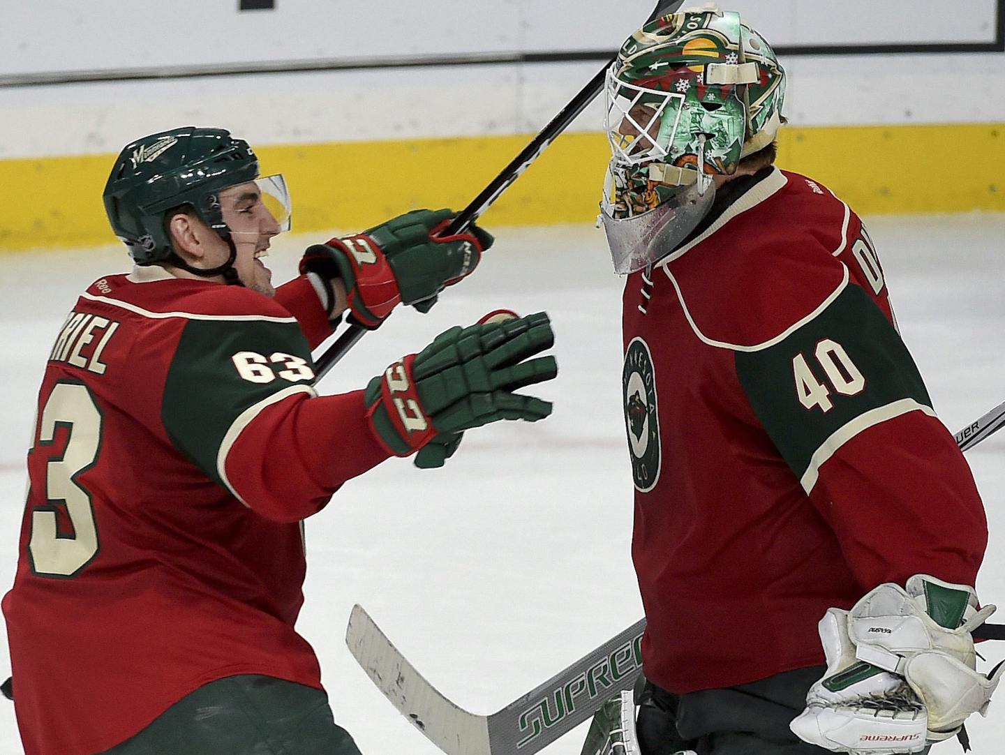 From left, Minnesota Wild's right wing Chris Stewart, right wing Kurtis Gabriel and goalie Devan Dubnyk celebrate after defeating the Edmonton Oilers in a shootout during an NHL hockey game, Friday, Dec. 9, 2016, in St. Paul, Minn. The Wild win 3-2 in the shootout. (AP Photo/Craig Lassig)