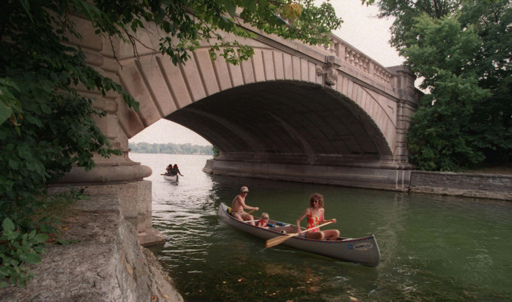 -- A flotilla of canoists and kayakers took to the waters of Mpls city lakes on a perfect summer day,- this the the bridge on the west side of isles and the channel connecting to Cedar Lake ORG XMIT: MIN2013110714272837