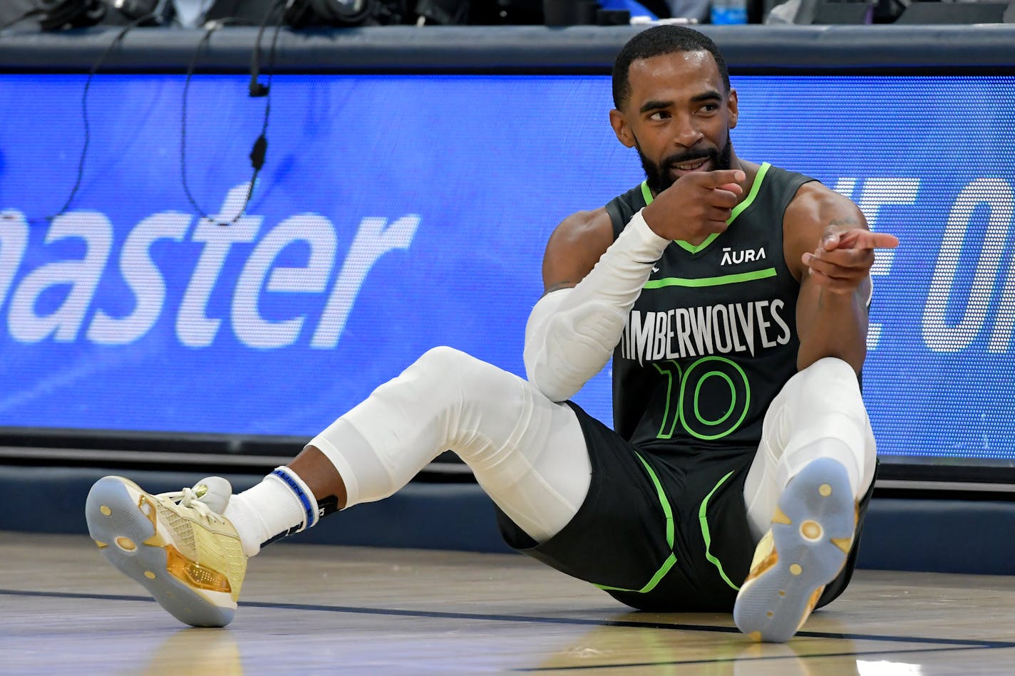 Minnesota Timberwolves guard Mike Conley (10) gestures in the first half of an NBA basketball game against the Memphis Grizzlies, Sunday, Nov. 26, 2023, in Memphis, Tenn. (AP Photo/Brandon Dill)