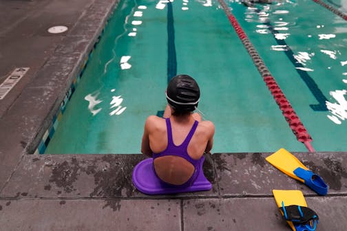 A proposed ban on transgender athletes playing female school sports in Utah would affect transgender girls like this 12-year-old swimmer seen at a pool in Utah on Monday, Feb. 22, 2021. She and her family spoke with The Associated Press on the condition of anonymity to avoid outing her publicly. She cried when she heard about the proposal that would ban transgender girls from competing on girls' sports teams in public high schools, which would separate her from her friends. She's far from the tallest girl on her team, and has worked hard to improve her times but is not a dominant swimmer in her age group, her coach said. "Other than body parts I've been a girl my whole life," she said. (AP Photo/Rick Bowmer)