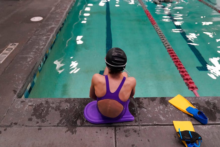 A proposed ban on transgender athletes playing female school sports in Utah would affect transgender girls like this 12-year-old swimmer seen at a pool in Utah on Monday, Feb. 22, 2021. She and her family spoke with The Associated Press on the condition of anonymity to avoid outing her publicly. She cried when she heard about the proposal that would ban transgender girls from competing on girls' sports teams in public high schools, which would separate her from her friends. She's far from the tallest girl on her team, and has worked hard to improve her times but is not a dominant swimmer in her age group, her coach said. "Other than body parts I've been a girl my whole life," she said. (AP Photo/Rick Bowmer)