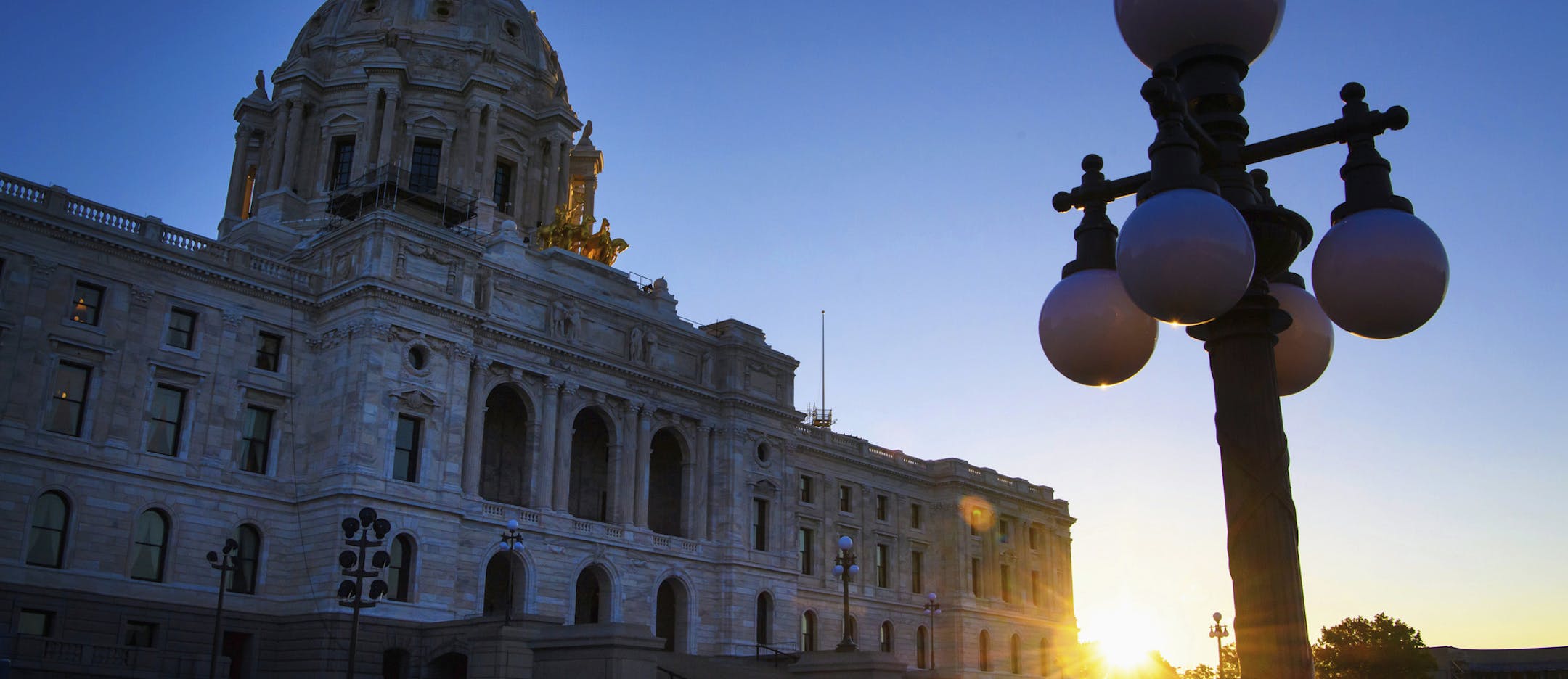 FILE - In this May 24, 2017, file photo, sun rises behind the Minnesota State Capitol in St. Paul, Minn. Minnesota lawmakers return to Capitol on Tuesday, Feb. 20, 2018, with a long list of work, and not much time to tackle it. The Legislature will discuss big-time tax code revisions, opioid abuse prevention efforts and possible constitutional amendments on the November ballot. (Glen Stubbe/Star Tribune via AP, File)