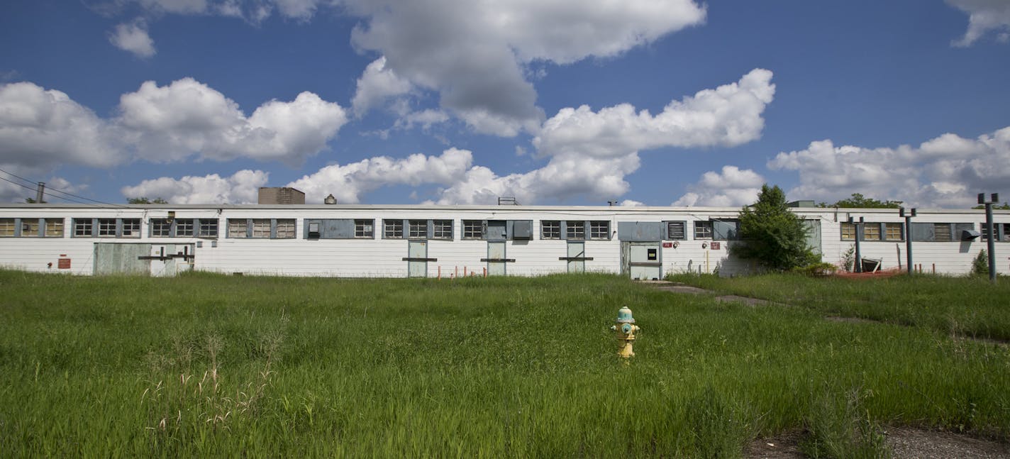 Top, Building 502, the most polluted with PCB contamination. Lower left, a hole in a wall revealed a building yet to be torn down. Right, a pile of steel to be recycled.