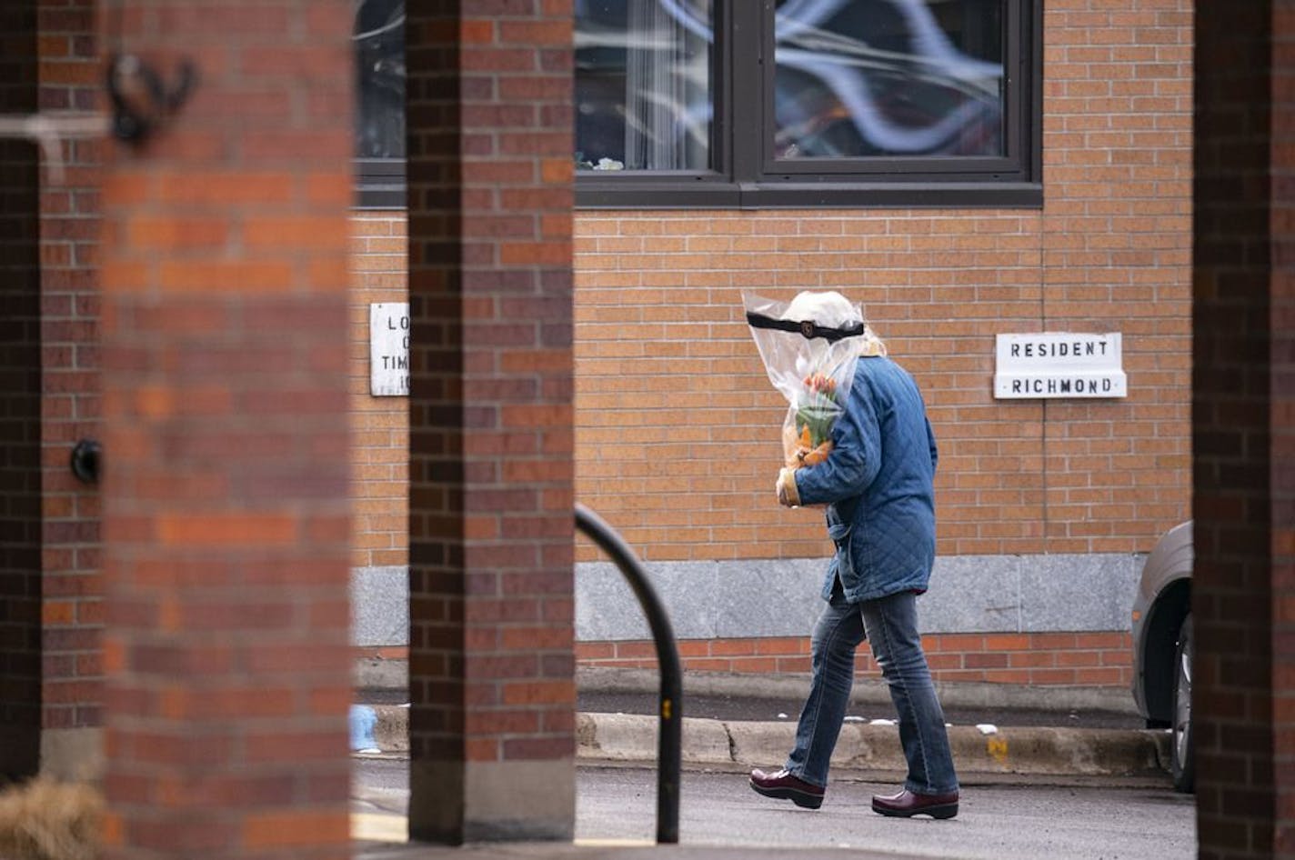 A woman walked towards the front door of St. Ann's Residence in Duluth, MN with flowers in hand on Thursday morning. The residence has reported COVID-19 cases among it's residents on Wednesday April 8, 2020.