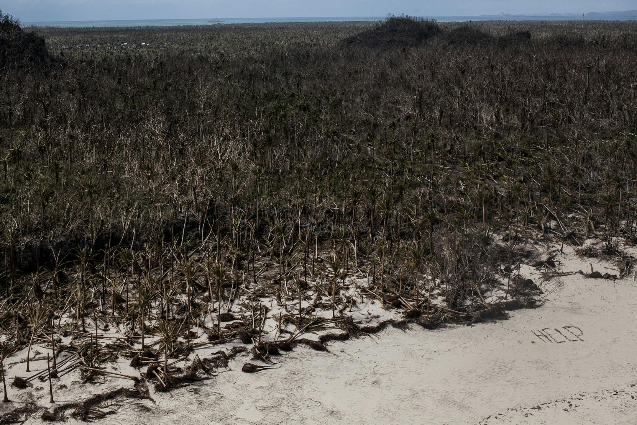 An aerial view of the word help written in the sand in Guiuan, Philippines, Nov. 19, 2013. More than a week after Typhoon Haiyan, the Philippines faces a multitude of questions about the needs of some 13 million people affected by the storm. (Bryan Denton/The New York Times)