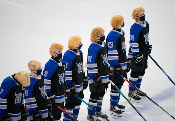 The Dodge County Wildcats had their playoff hair on display during team introductions. ] JEFF WHEELER • jeff.wheeler@startribune.com