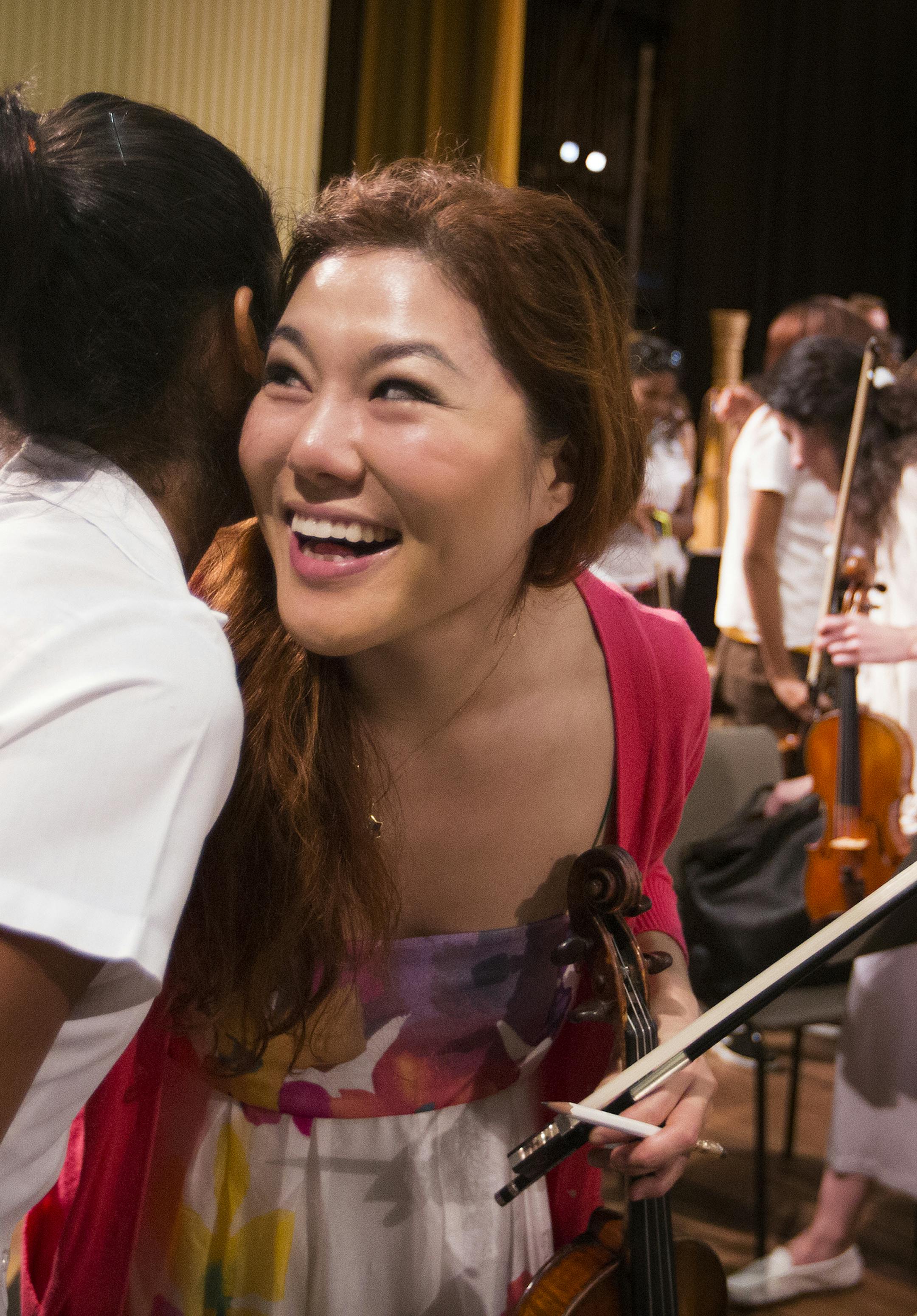 Violin player Christa Morena of the Orquesta Sinfonica Juvenil del Conservatorio gets a hug from violin player Susie Park, right, of the Minnesota Orchestra after a side-by-side rehearsal with at Teatro Nacional in Havana, Cuba on Friday, May 15, 2015. ] LEILA NAVIDI leila.navidi@startribune.com /
