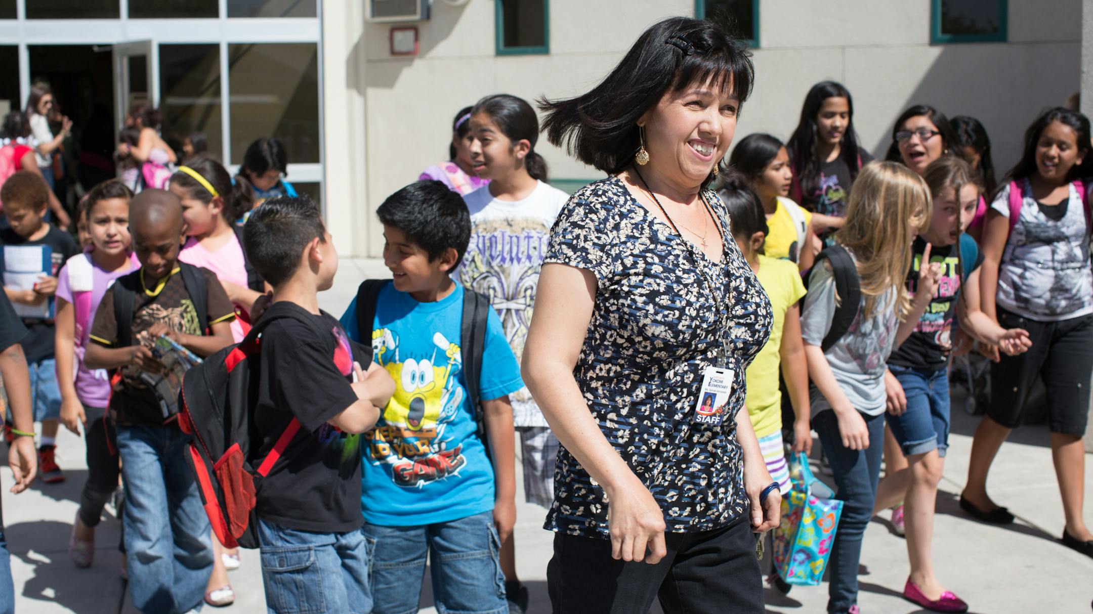 Sylvia Gonzalez walks her second grade students to be picked up after school at Yokomi Elementary in Fresno, CA. Photo by Tomas Ovalle