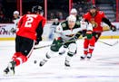 Minnesota Wild's Charlie Coyle attempts to move the puck past Ottawa Senators' Dion Phaneuf during first period NHL hockey action in Ottawa on Tuesday