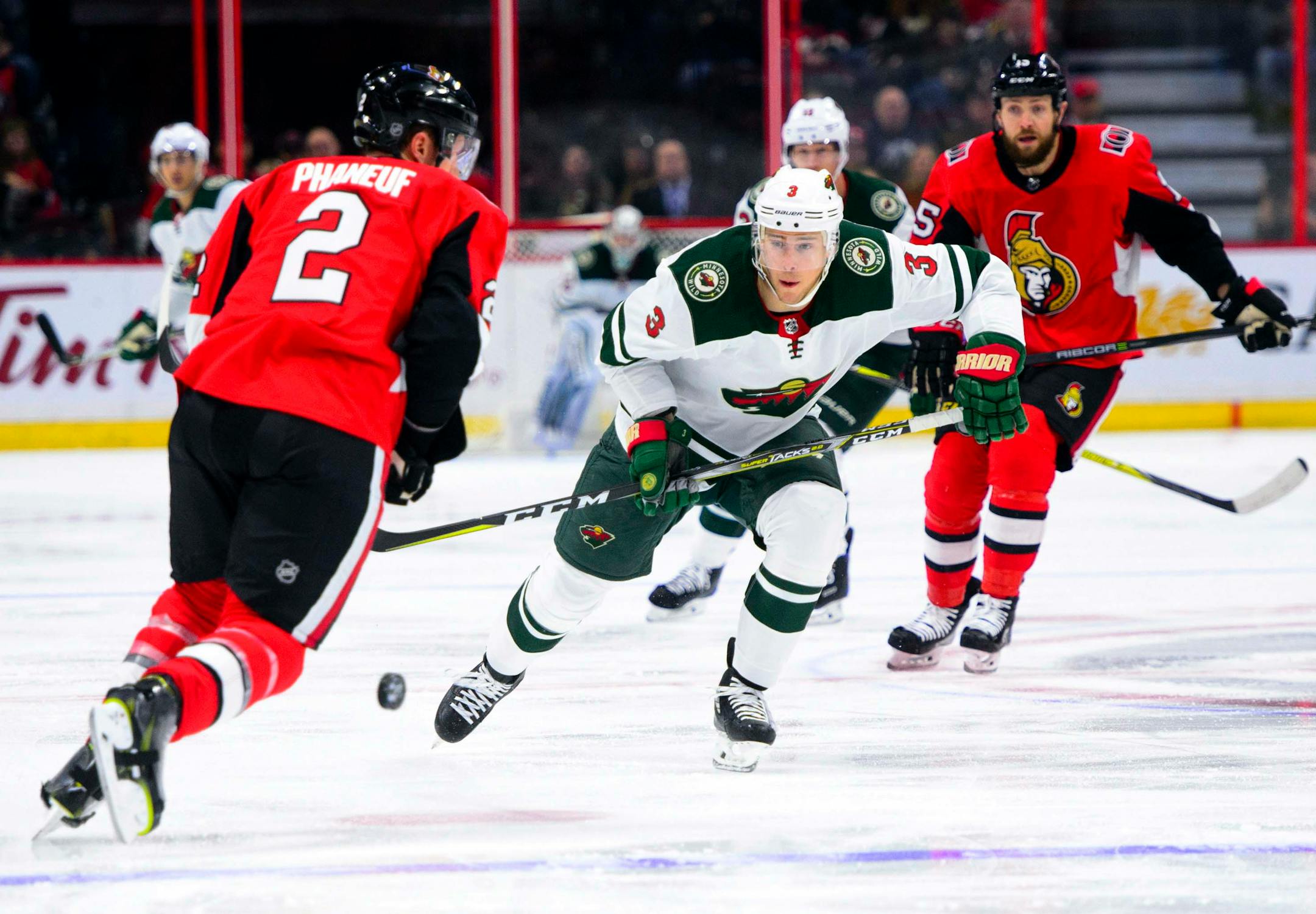 Minnesota Wild's Charlie Coyle attempts to move the puck past Ottawa Senators' Dion Phaneuf during first period NHL hockey action in Ottawa on Tuesday, Dec. 19, 2017. (Sean Kilpatrick/The Canadian Press via AP)
