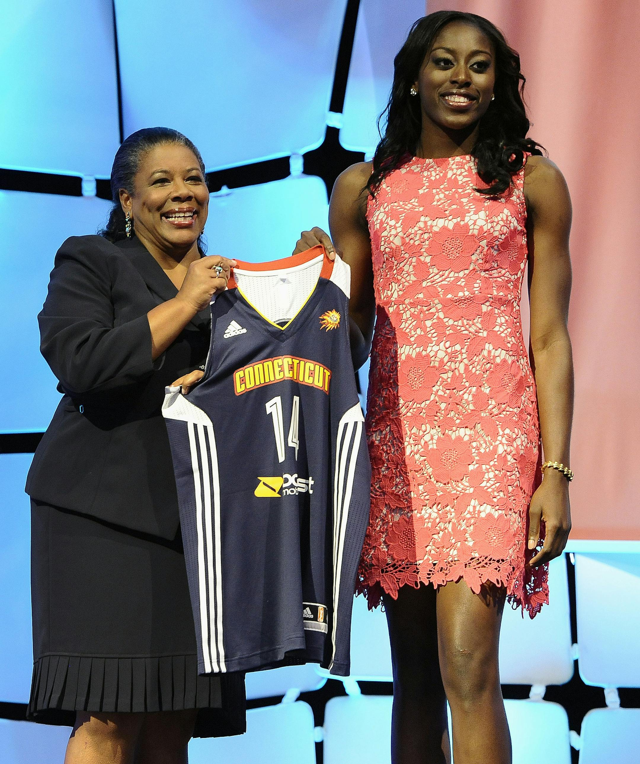 Stanford’s Chiney Ogwumike holds up Connecticut Sun jersey with WNBA president Laurel J. Richie after Connecticut named Ogwumike as the No. 1 pick in the WNBA basketball draft in, Monday, April 14, 2014, in Uncasville, Conn. (AP Photo/Jessica Hill)