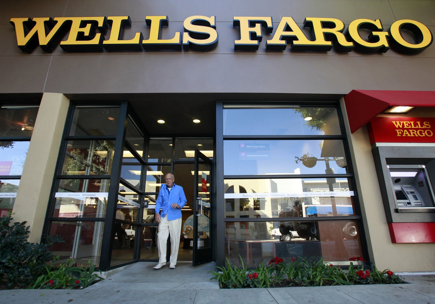 FILE - In this Jan. 18, 2011 file photo, a customer exits a Wells Fargo bank branch in Los Angeles. Are banks strong enough to spare some cash? The country will get the answer Thursday, March 15, 2012, when the Federal Reserve releases results of its so-called stress tests on the 19 largest U.S. financial institutions. (AP Photo/Reed Saxon, file) ORG XMIT: MIN2012101215441807