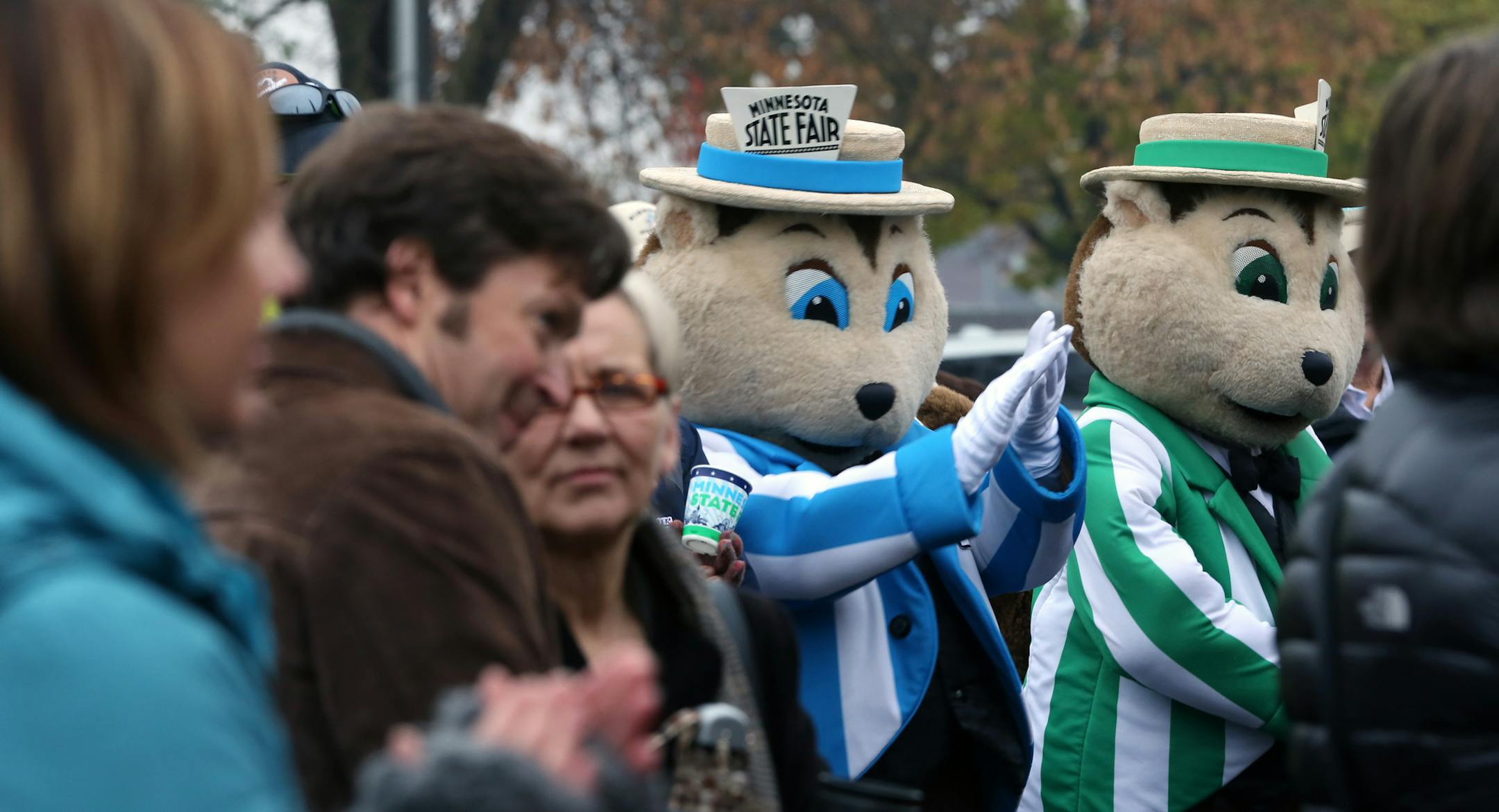 A small audience, Fairborn, (nephew of Fairchild, the original fair mascot), and Fairchild, applauded as Jerry Hammer, Executive Vice-President & General Manager of the Minnesota State Fair unveiled plans for the new Heritage Square at the Minnesota State Fair Grounds on 10/30/13.] Bruce Bisping/Star Tribune bbisping@startribune.com Fairborn, Fairchild, Jerry Hammer/source.