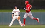 Los Angeles Angels' Ian Kinsler, right, passes by Minnesota Twins second baseman Brian Dozier as he rounds the bases on a solo home run off Twins pitc