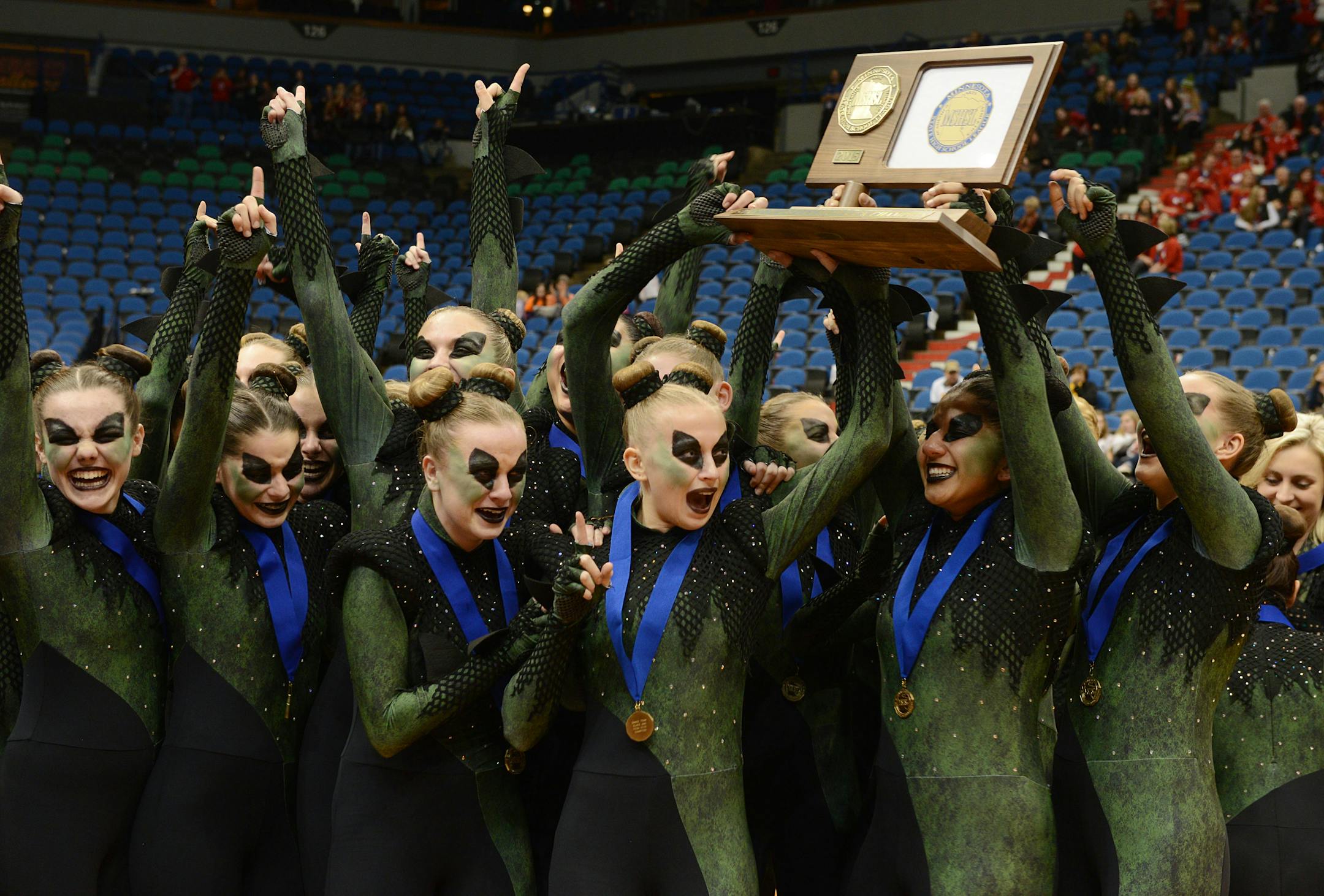 Faribault Emeralds dance team celebrates their announcement of first place in the 3AAA state dance team high kick division tournament by cheering and holding up their trophy on Saturday at Target Center.] BRIDGET BENNETT � Special to the Star Tribune bridget.bennett@startribune.com Saturday Feb. 14, 2015 at Target Center MSHSL dance team state tournament high kick division 3AAA 1st faribault emeralds Lakeview South, Eastview, Eden Prairie, Wayzata, and Chaska dance teams all hold hands. I was to