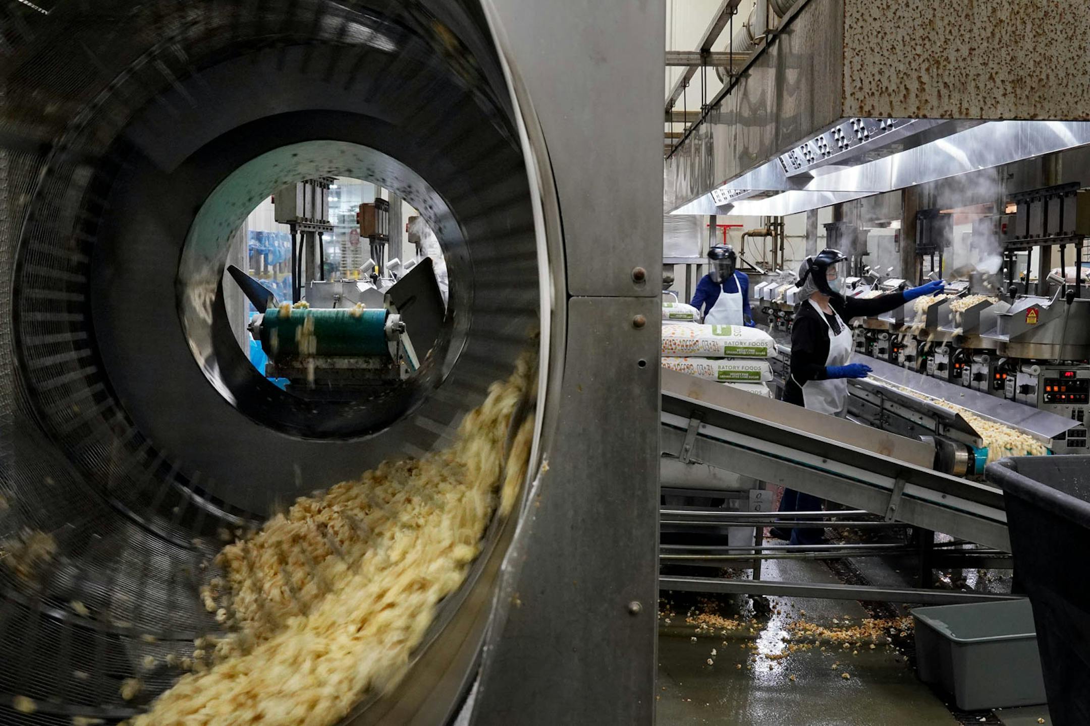 Popcorn moved via conveyor to a sifter at Kenny's Candy & Confections.